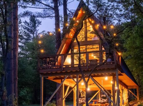 Designer A-Frame Treehouse with hot tub on river in Johnson